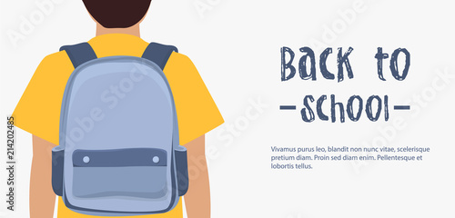 Schoolboy going to school with backpack. Back view.
