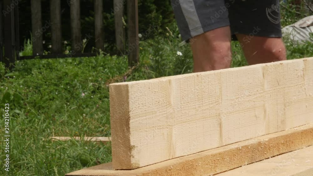 man working on a wood planing machine. Chips fly in different side from the planer. 4K man working on a wood planing machine. Chips fly in different side from the planer. 4K