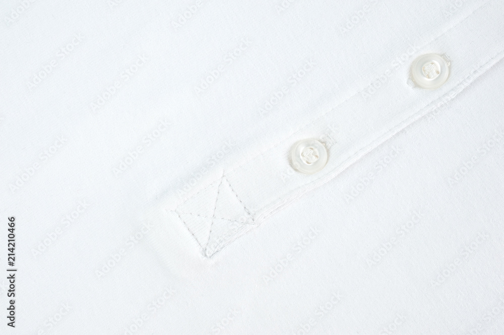 White button sewn on a woolen fabric shot close-up White button sewn on a woolen fabric shot close-up