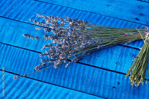 Fototapeta Naklejka Na Ścianę i Meble -  Bunch of lavender on the blue wooden desk.