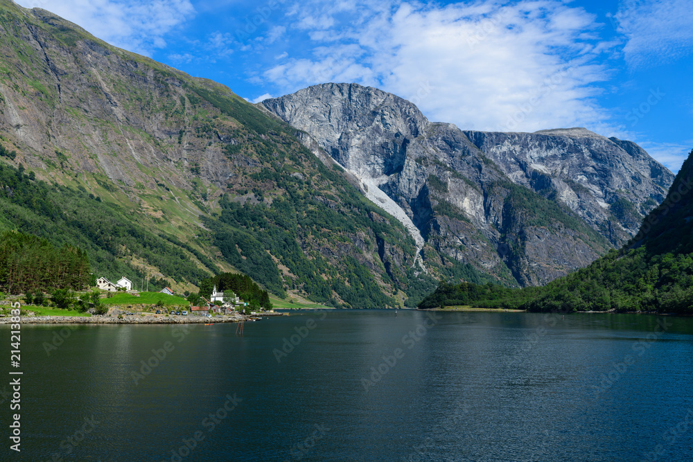 Landscape with the village on the banks of Neroyfjord. Neroyfjord offshoot of Sognefjord is the narrowest fjord in Europe. Hardaland, Norway, Europe.