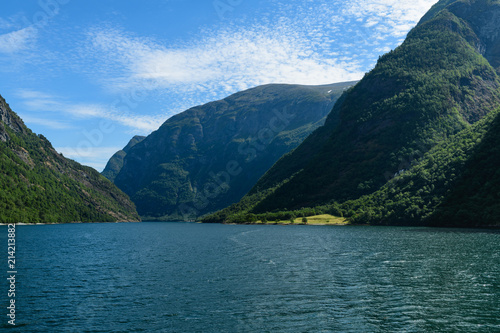  Seascape of the Neufjord from the boat. Neroyfjord offshoot of Sognefjord is the narrowest fjord in Europe. Hardaland, Norway, Europe. © a_mikhail