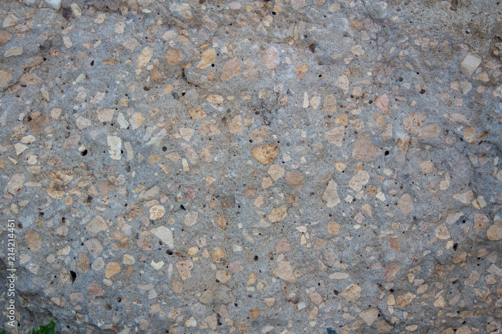 The texture of a gray stone with yellow impregnations The texture of a gray stone with yellow impregnations