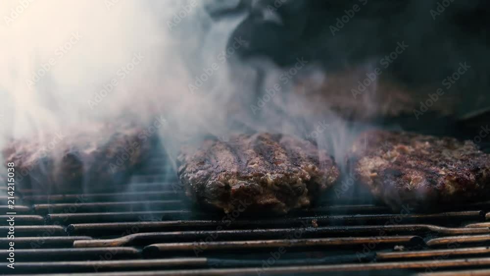 Smoke rising off of hamburger patties on a charcoal BBQ Smoke rising off of hamburger patties on a charcoal BBQ