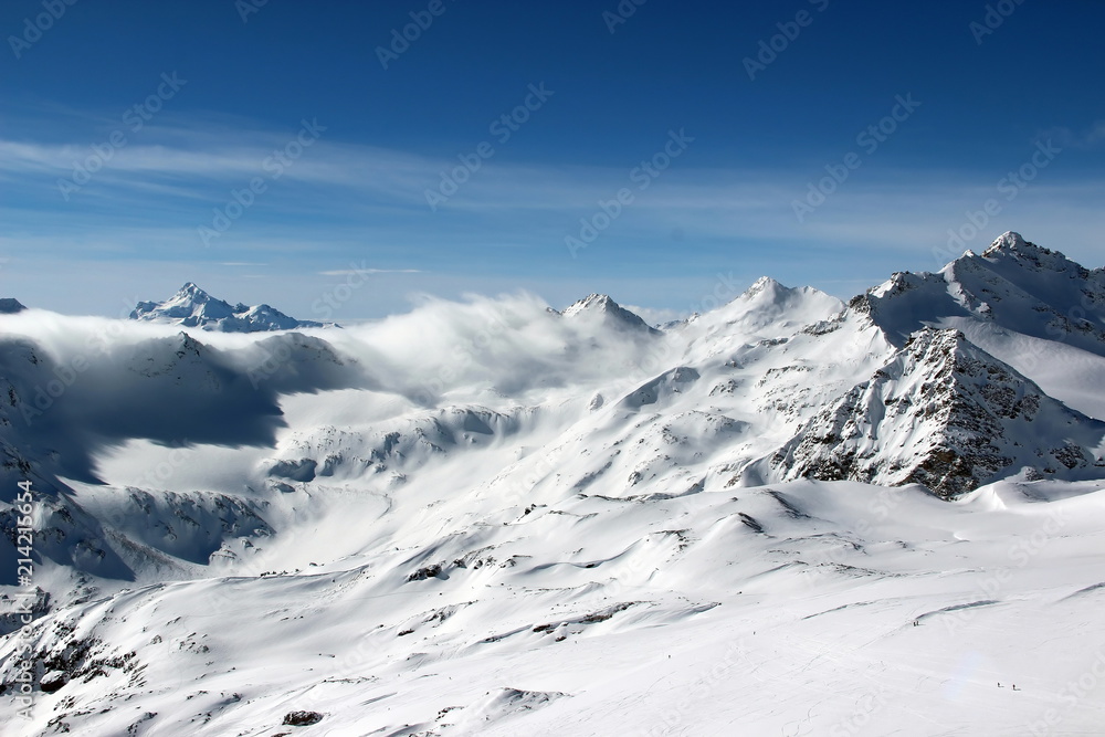 Snowy Mountains in the clouds blue sky Caucasus Elbrus