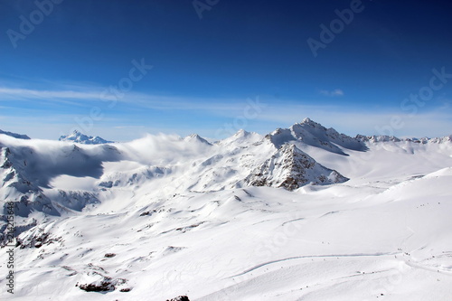 Snowy Mountains in the clouds blue sky Caucasus Elbrus © Mokrousov Boris