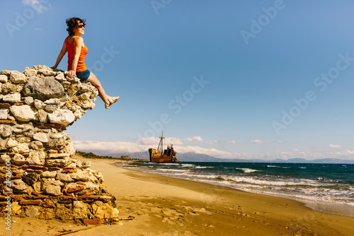 Tourist woman on beach enjoying vacation