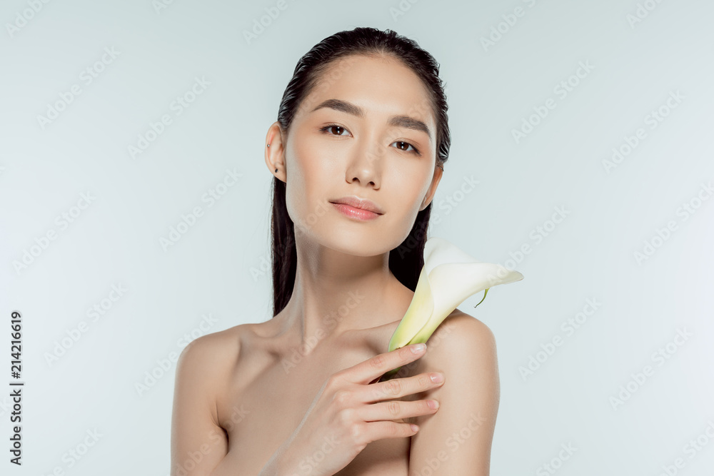 beautiful nude asian girl posing with calla flower, isolated on grey beautiful nude asian girl posing with calla flower, isolated on grey