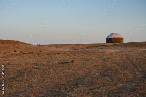 Traditional yurt in the middle of Turkmen desert at sunset. photo
