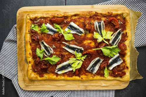 Pizza Marinara garnished with anchovies and parsley