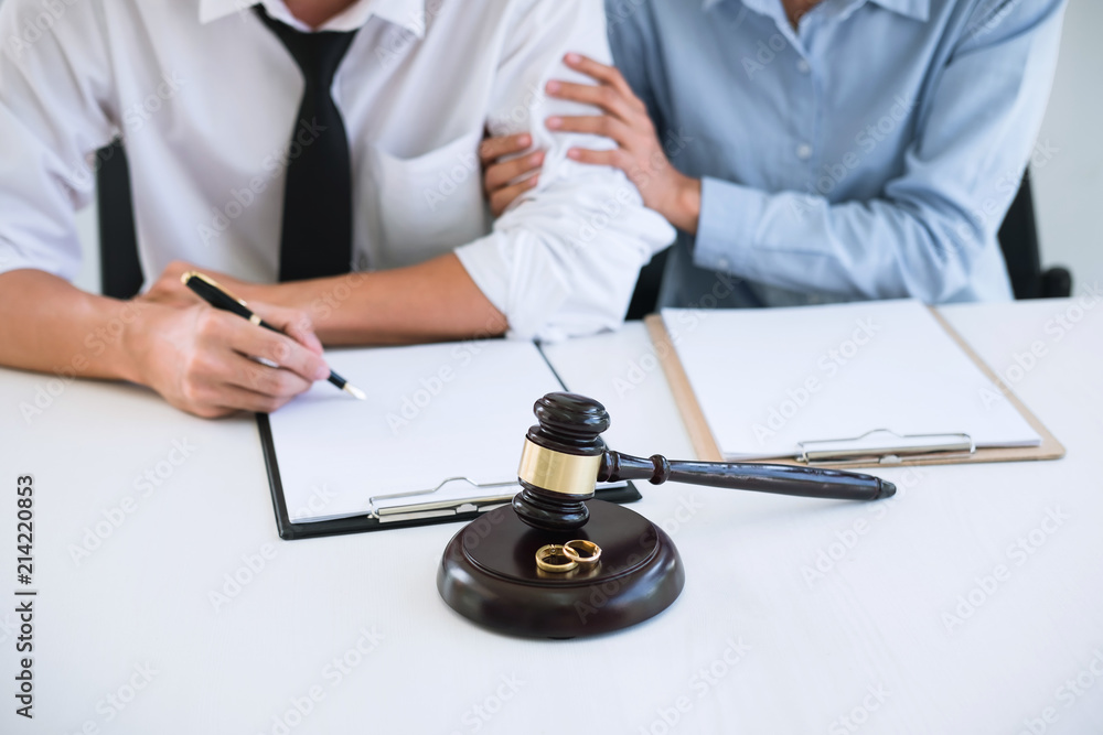 Decree of divorce (dissolution or cancellation) of marriage, husband and wife during divorce process with lawyer or counselor and signing of divorce contract Decree of divorce (dissolution or cancellation) of marriage, husband and wife during divorce process with lawyer or counselor and signing of divorce contract