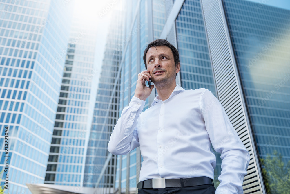 Businessman on cell phone in the city