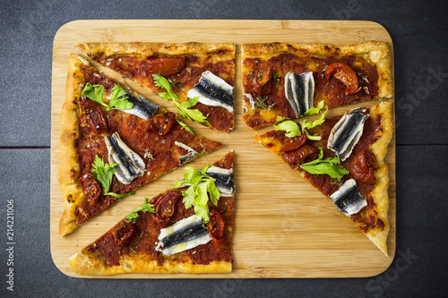 Pizza Marinara garnished with anchovies and parsley
