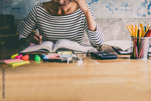 Young student sitting at desk in home studying and reading, doing homework and lesson practice preparing exam to entrance, education concept photo