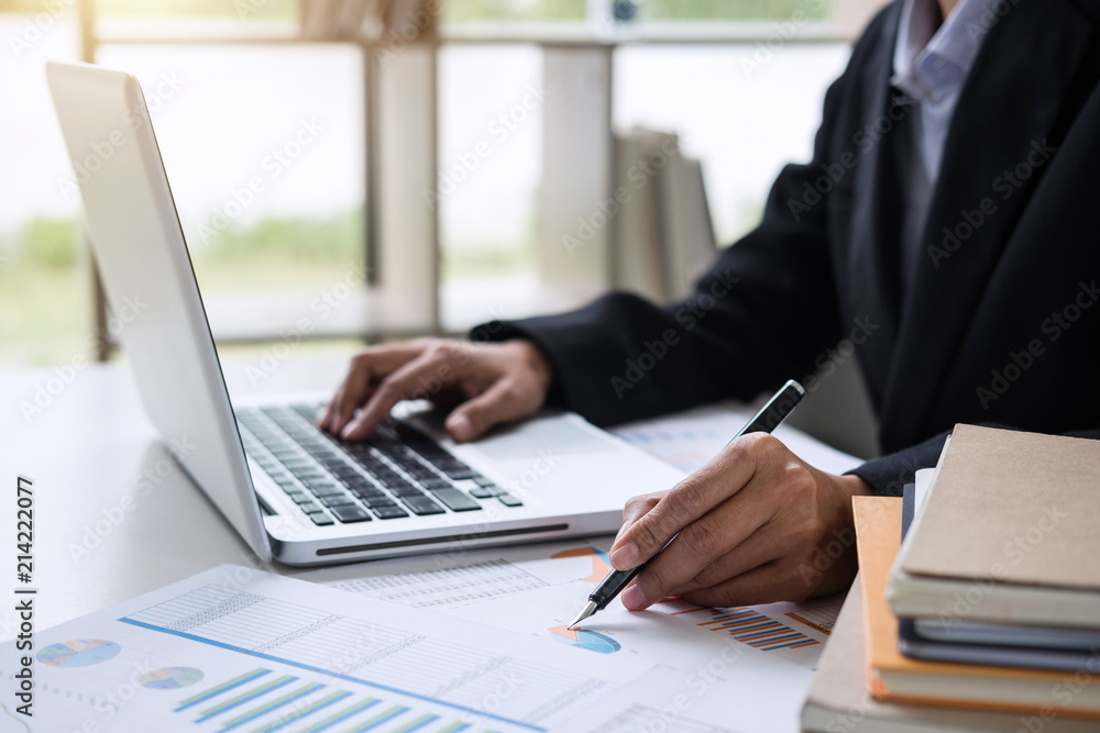 Female accountant calculations and analyzing financial graph data with calculator and laptop Business, Financing, Accounting, Doing finance, Economy, Savings Banking Concept Female accountant calculations and analyzing financial graph data with calculator and laptop Business, Financing, Accounting, Doing finance, Economy, Savings Banking Concept