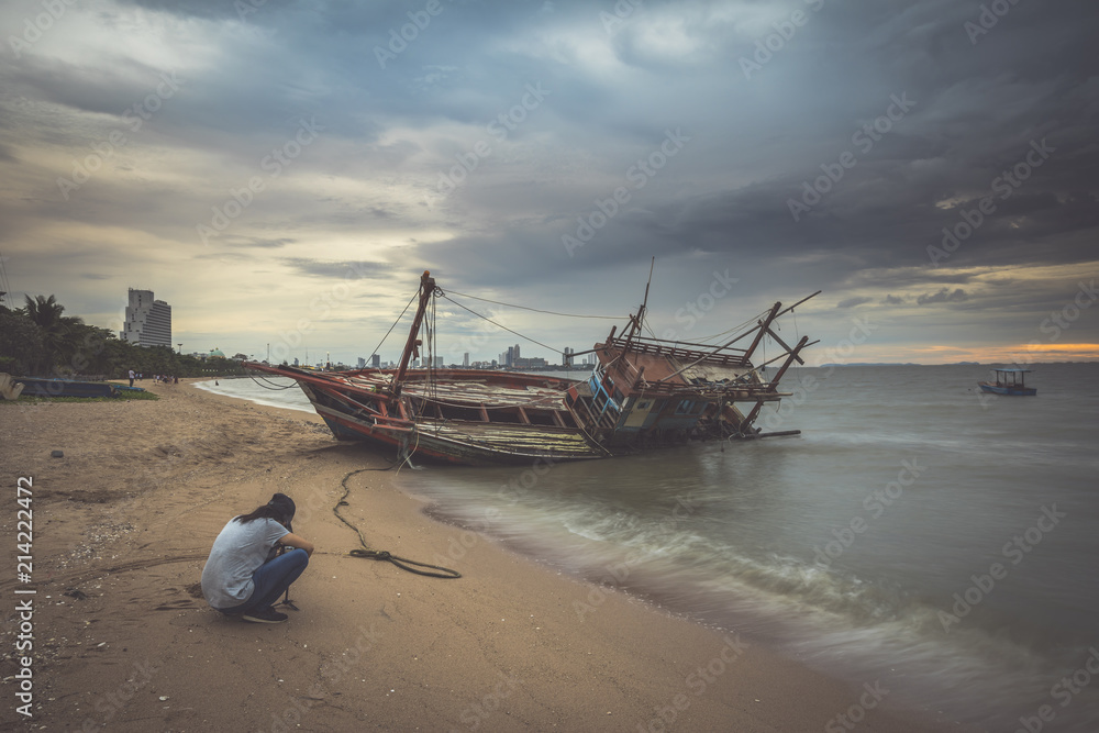 Boat crashes in the sea,Thailand. An old shipwreck on beach. Pattaya beach, Chonburi, Thailand.
