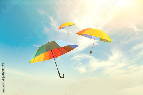 Colorful umbrellas floating against a beautiful sky