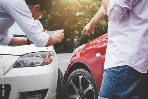 Two drivers man arguing after a car traffic accident collision and making phone call to Insurance Agent and take a photo, Traffic Accident and insurance concept photo