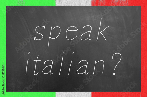 Speak Italian chalk text on flag frame blackboard.