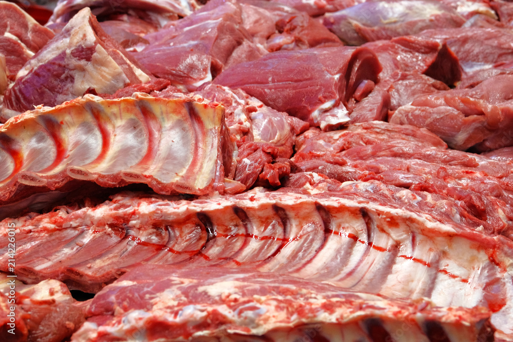 Assortment of various fresh raw meat at local farmers market. Ribs, fillets, tenderloin, steaks. Assortment of various fresh raw meat at local farmers market. Ribs, fillets, tenderloin, steaks.