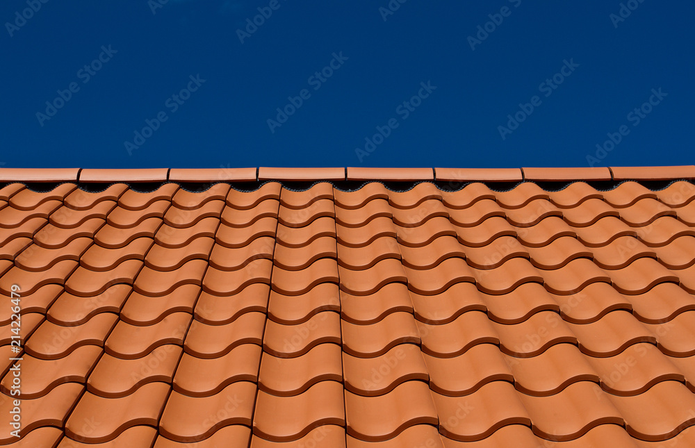House roof with new tiles. Tile roof and blue sky