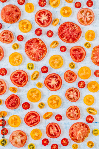 Slices of Tomatoes Over Blue Background