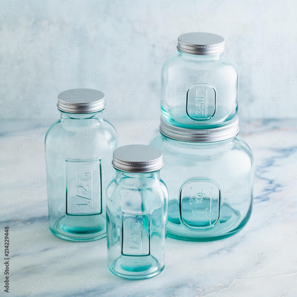 Glass jars, ready for sterilization and canning. preservation of food on a marble table. Glass jars, ready for sterilization and canning. preservation of food on a marble table.