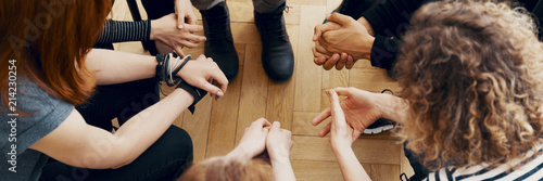 High angle view of hands of people in group therapy, talking and supporting each other photo