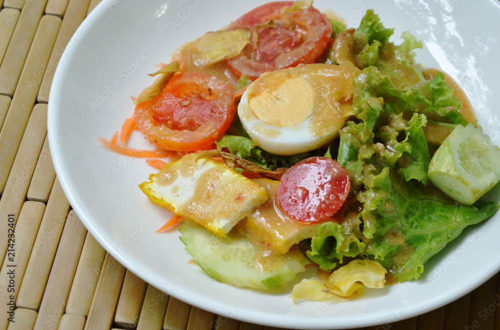 fresh vegetable topping boiled egg dressing Indian sauce salad on plate fresh vegetable topping boiled egg dressing Indian sauce salad on plate