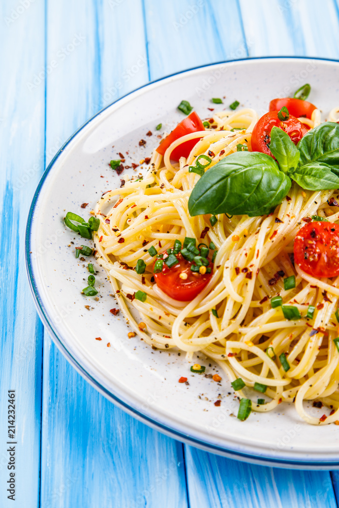 Pasta with vegetables on wooden table Pasta with vegetables on wooden table