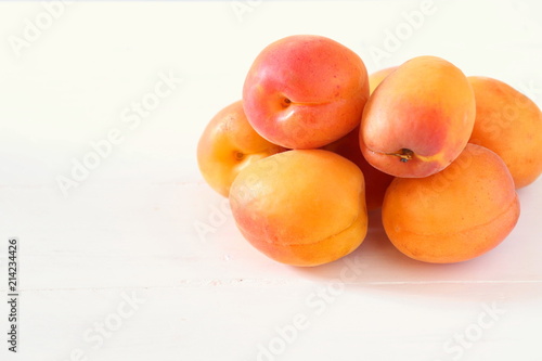 Fresh apricots on white surface
