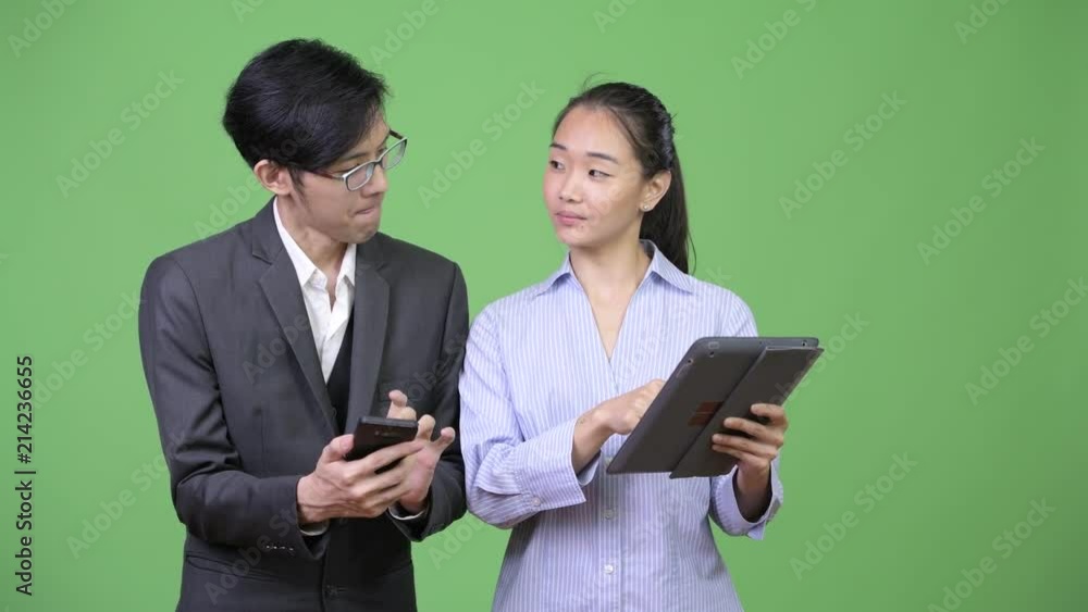 Young Asian business couple having meeting together Young Asian business couple having meeting together