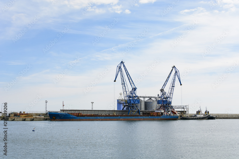 Crane and cargo ship in the Balchik bay in Bulgaria.