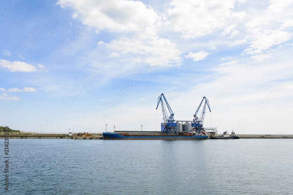 Crane and cargo ship in the Balchik bay in Bulgaria.