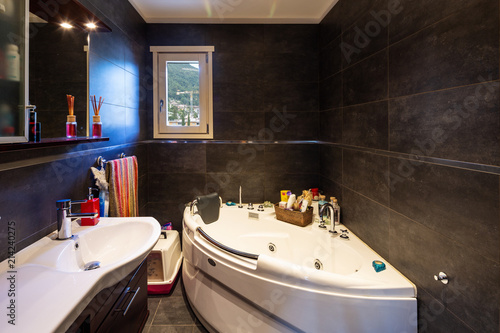 Modern bathroom with large dark tiles