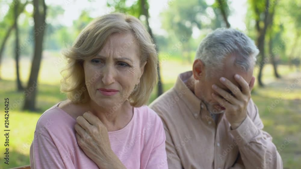 Elderly couple crying, frustrated with illness of close relative, despair Elderly couple crying, frustrated with illness of close relative, despair