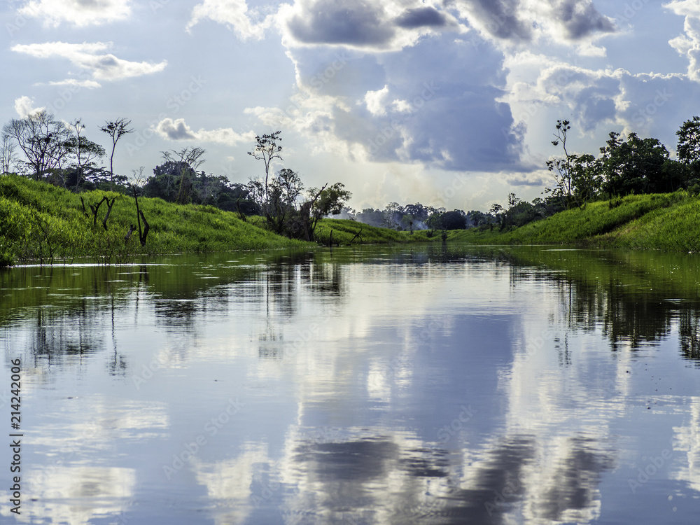 Scenic picture of Amazon river reflecting dramatic sky and clouds