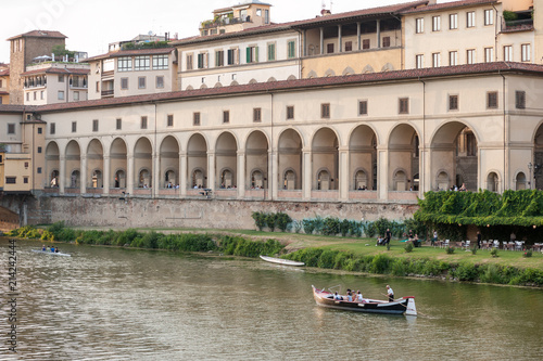 Tourists sailing along the Arno river, on a sightsseeing tour, near the Vasari corridor in Florence, Italy.
 photo