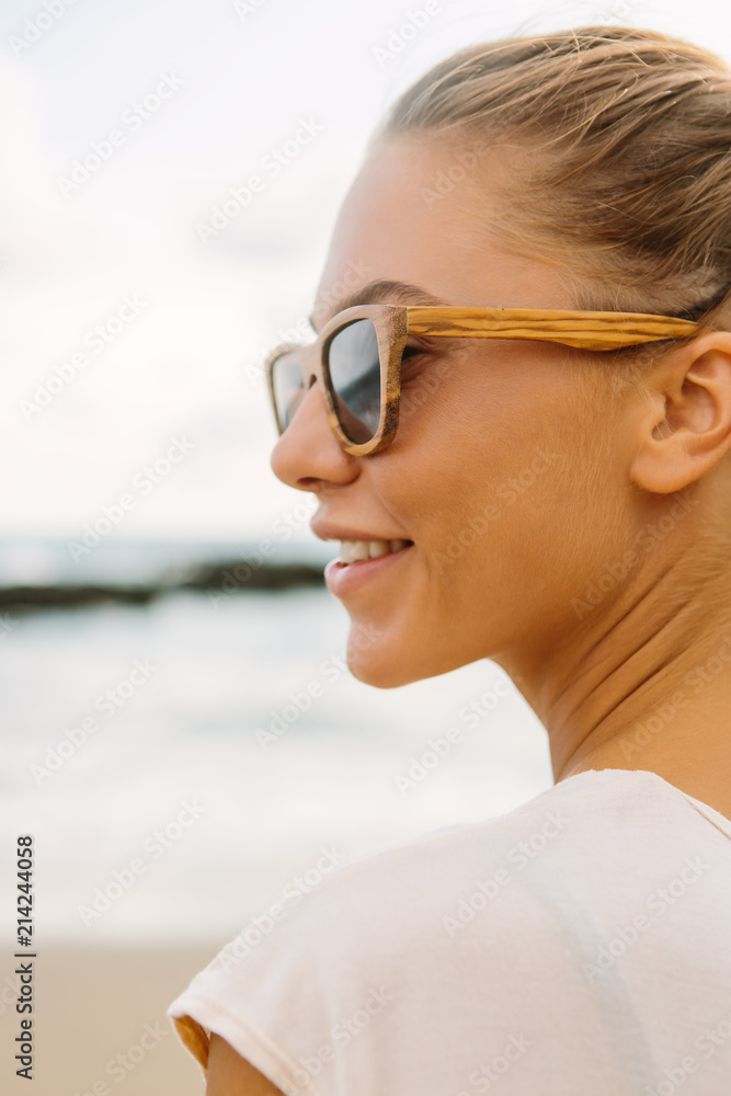 Close up portrait of pretty woman in casual summer dress and wooden sunglasses. Sexy lady on sea tropic beach sunset or ocean sunrise. Travel, explore, active yoga and meditation lifestyle concept. Close up portrait of pretty woman in casual summer dress and wooden sunglasses. Sexy lady on sea tropic beach sunset or ocean sunrise. Travel, explore, active yoga and meditation lifestyle concept.