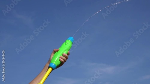 Child shooting water with squirt gun HD