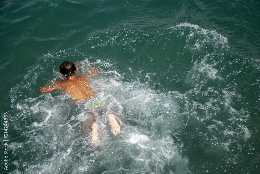 Fototapeta premium Children swim in the sea