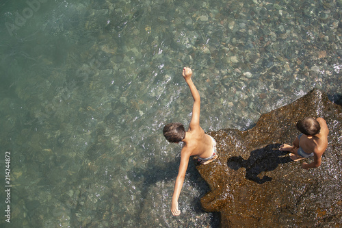 Children jump from above into the water and bathe