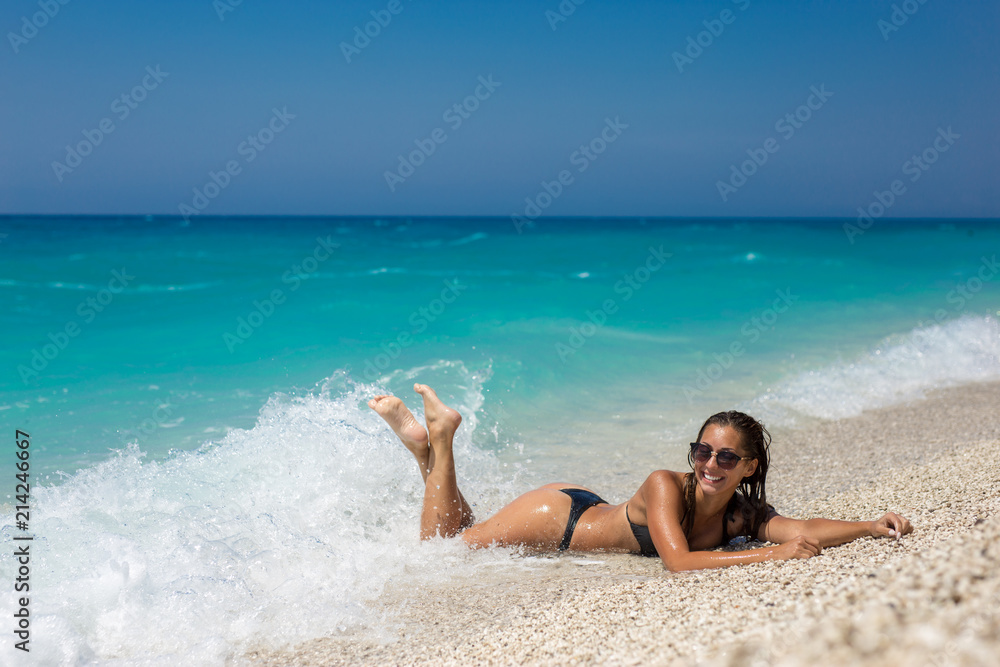 Beautiful young woman lying on the beach