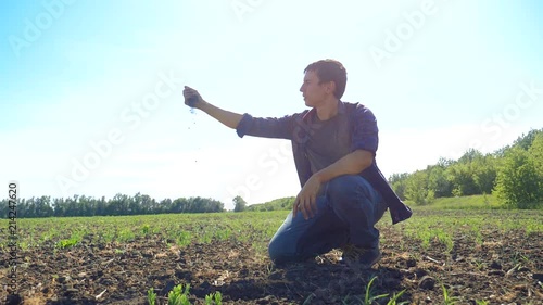 man farmer working peasant hands holding fresh soil. slow motion video. man ground dirt keeps the soil Symbol of spring and ecology concept. agriculture worker working in the field. lifestyle man