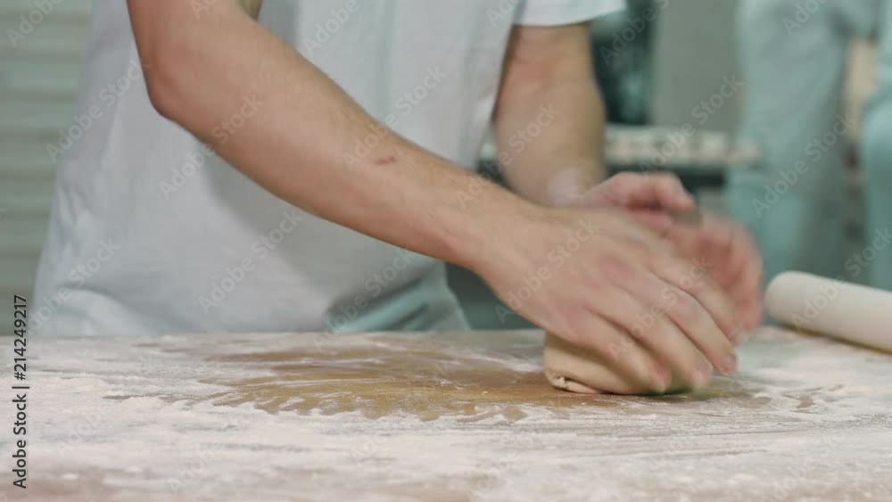 The cook rolls out the dough. The cook rolls out the dough.