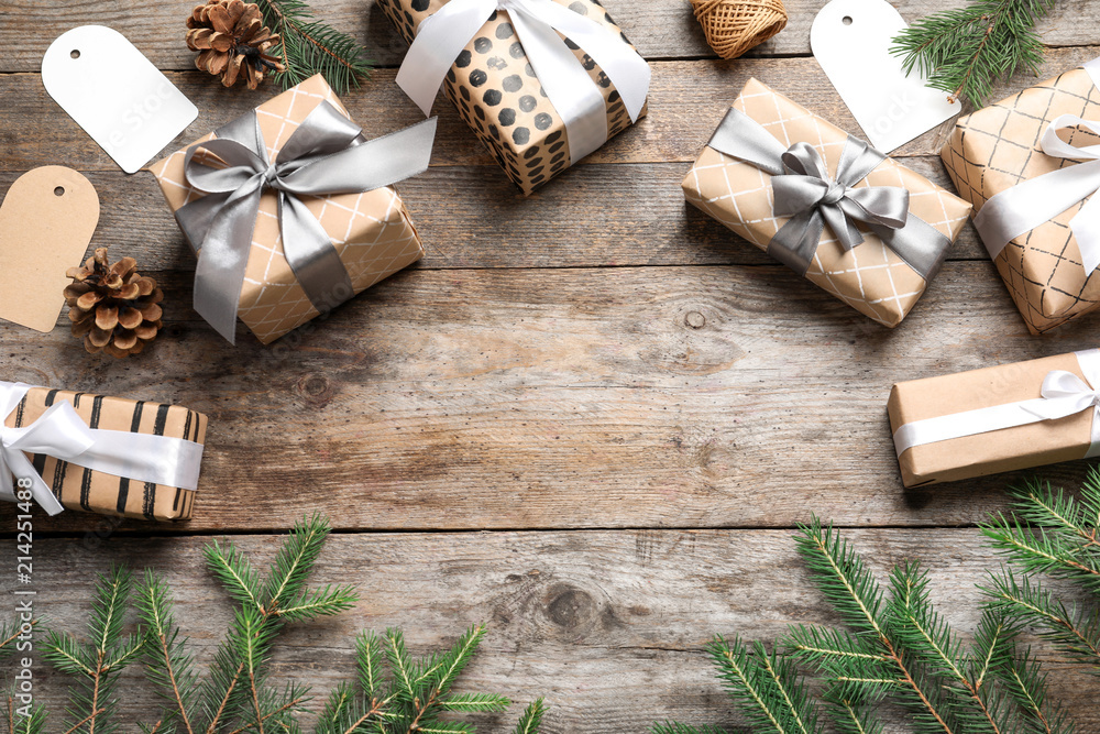 Flat lay composition with Christmas gifts and fir branches on wooden background Flat lay composition with Christmas gifts and fir branches on wooden background