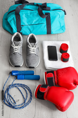 Composition with sports bag on wooden floor