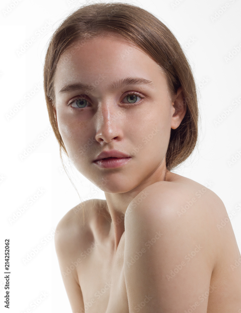 Fototapeta premium The beautiful gentle girl the blonde with ideal skin on a white background. Natural beauty, day make-up. Beauty, purity. Cosmetology and Spa procedures.