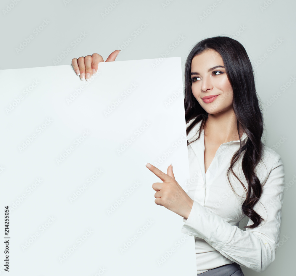 Smiling business woman pointing up and showing signboard with empty copy space area for tagline, advertisiment or text message on white background. Smiling business woman pointing up and showing signboard with empty copy space area for tagline, advertisiment or text message on white background.