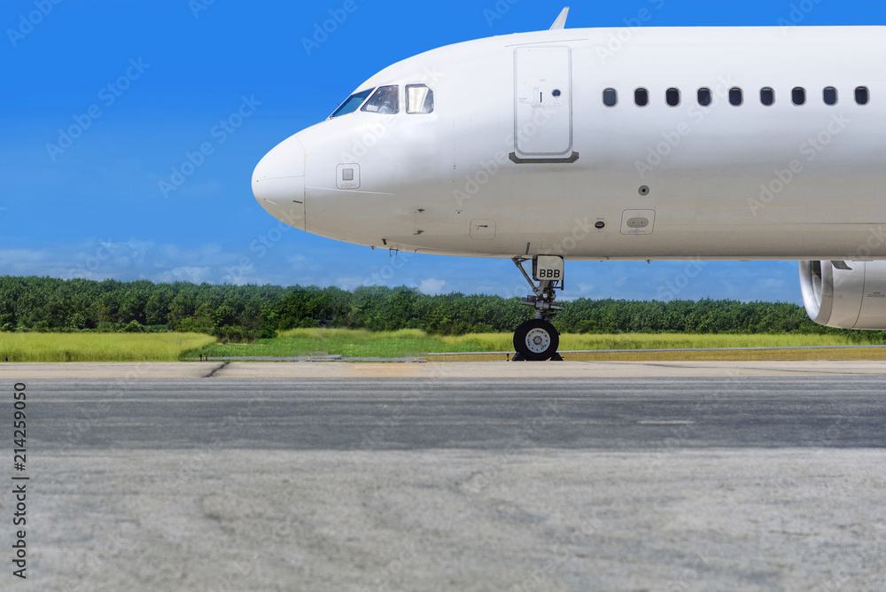 White jet airplane on runway and blue sky White jet airplane on runway and blue sky